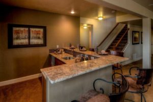 A wet bar with granite countertops